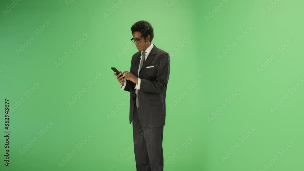 Businessman takes out phone and texts on green screen Businessman takes out phone and texts on green screen