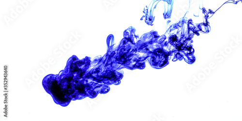 Blue ink injected into water from syringe, colour mixing with water creating abstract shapes, banner with space for text right side