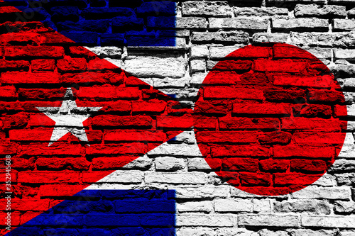 Cuban and Japan flag on brick wall