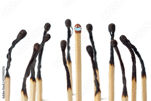 Burnt matches stand near unburnt on a white background. Understanding the importance of wearing a mask in a society of people during a virus.
