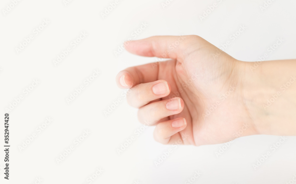 Close up woman hand with nails form of soft square holds something in fingers. Female keeps virtual object. Nail care at home. Copy space. Close up woman hand with nails form of soft square holds something in fingers. Female keeps virtual object. Nail care at home. Copy space.