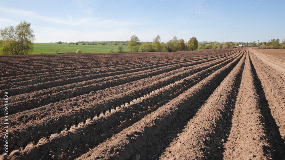 Colours of spring - ploughed field ready to sow. Agricultural fields in Russia. Colours of spring - ploughed field ready to sow. Agricultural fields in Russia.