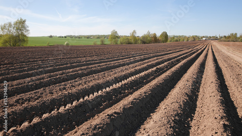 Colours of spring - ploughed field ready to sow. Agricultural fields in Russia.