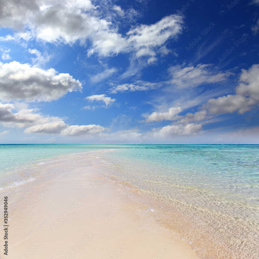white sandy sea spit beach leading into ocean white sandy sea spit beach leading into ocean