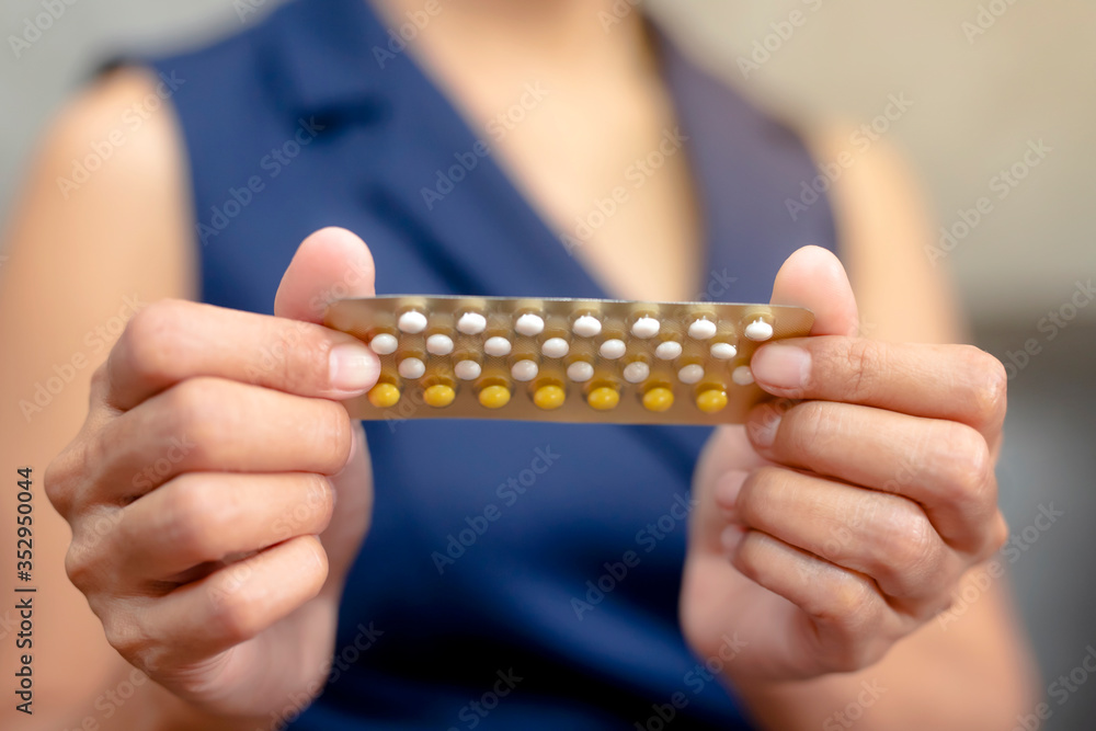Obraz premium Woman holding combined oral contraceptive pill.Gynecology concept.