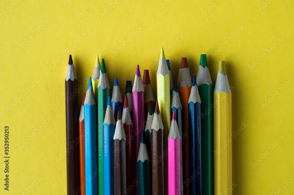 Circle of colour pencils on black background.Close up. Many different colored pencils on dark purple background.Colorful pencil. Circle of colour pencils on black background.Close up. Many different colored pencils on dark purple background.Colorful pencil.