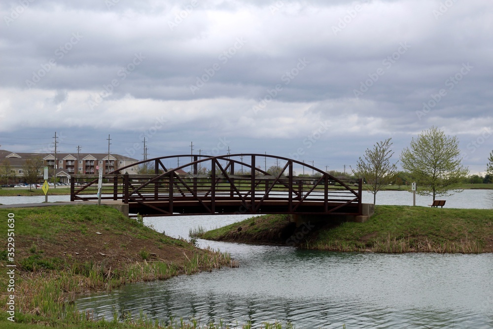 The old steel footbridge in the park on a overcast day.