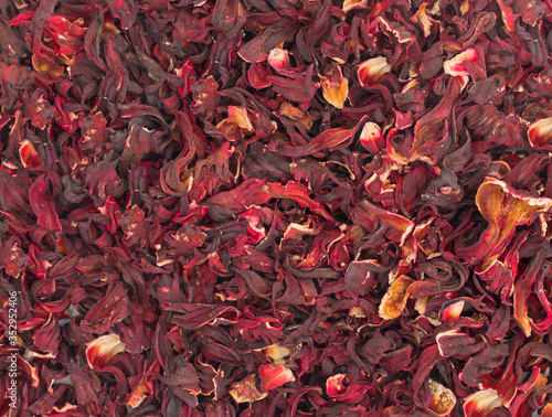 Dried petals of hibiscus tea background. Close up. Top view.