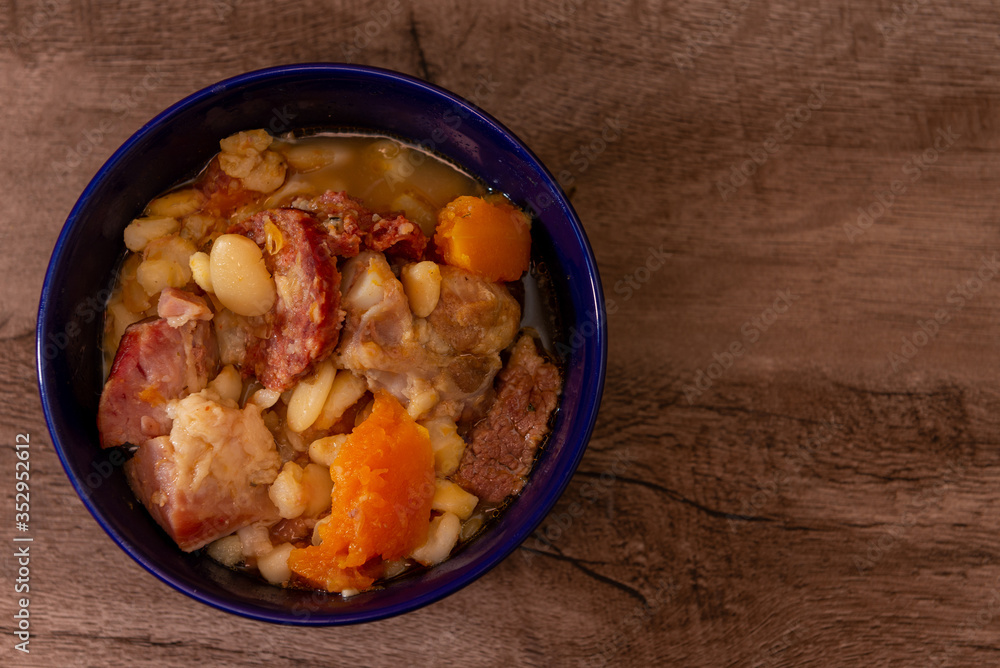 Locro, cocina argentina, un guiso muy popular hecho con calabaza, frijoles, maíz blanco, carne, salchichas, etc. Sobre una tabla de madera Locro, cocina argentina, un guiso muy popular hecho con calabaza, frijoles, maíz blanco, carne, salchichas, etc. Sobre una tabla de madera