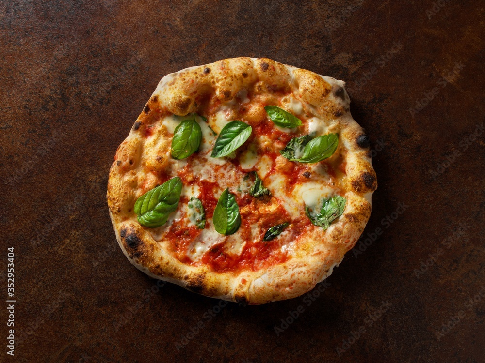Italian pizza on a brown background Italian pizza on a brown background