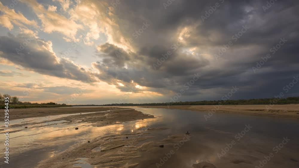 4k timelapse of the fast moving clouds above the river during the golden sunset. 4k timelapse of the fast moving clouds above the river during the golden sunset.