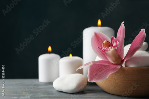 Candles  orchid and stones on wooden table. Zen concept