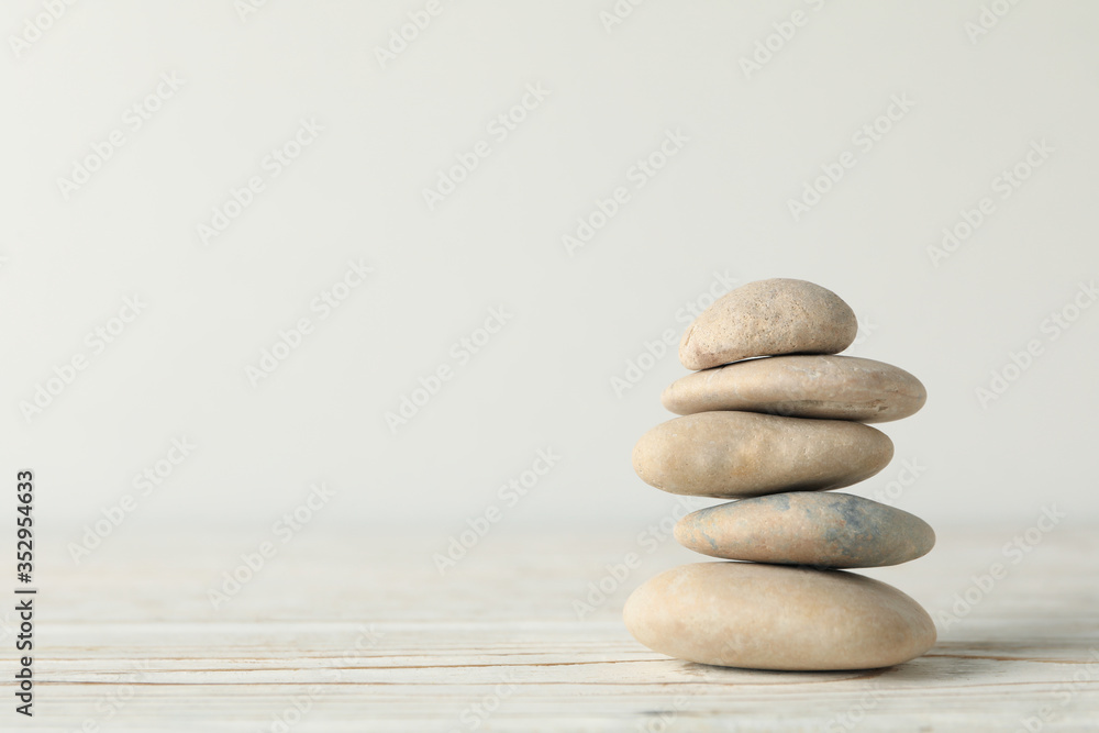 Pile of stones on wooden table. Zen concept