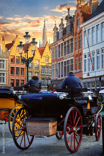 Bruges Belgium. Old town with vintage house at square with glowing lantern and sunset sky. Picturesque landmark in Europe.