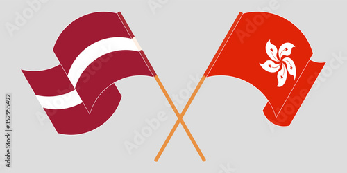 Crossed and waving flags of Hong Kong and Latvia