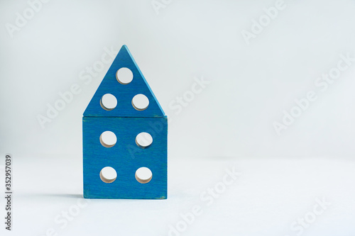 blue house made of wooden cubes on a light background