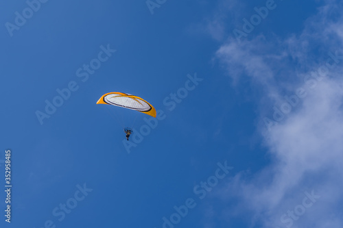 man flying on a paraglider in the sky