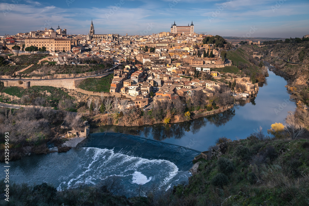 Cityscape of the monumental city of Toledo with the view of the old town and the Tajo river at the foot of the city, Spain.