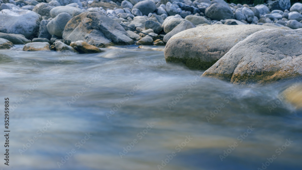 blue shade image of flowing water of the Italian stream Mollarino in the Lazio region,motion blur image blue shade image of flowing water of the Italian stream Mollarino in the Lazio region,motion blur image