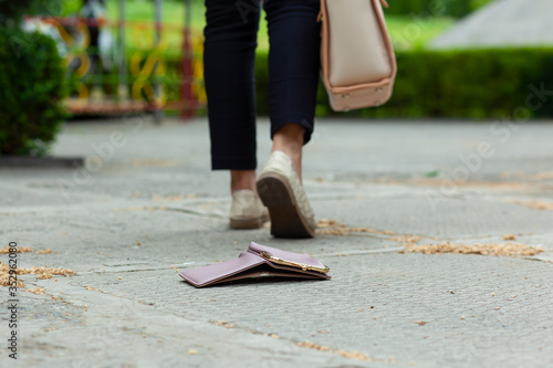 wallet in ground and woman in street
