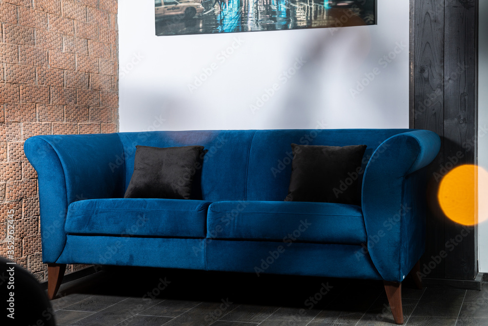 Blue Sofa in the room with white walls.