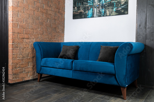 Blue Sofa in the room with white walls.