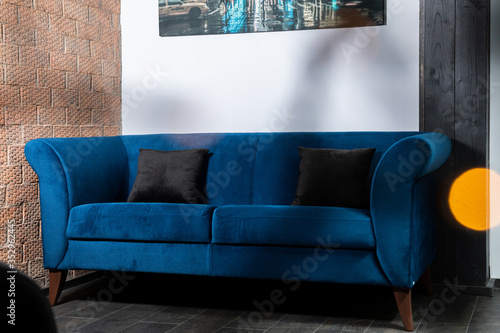 Obraz na płótnie Blue Sofa in the room with white walls. w salonie