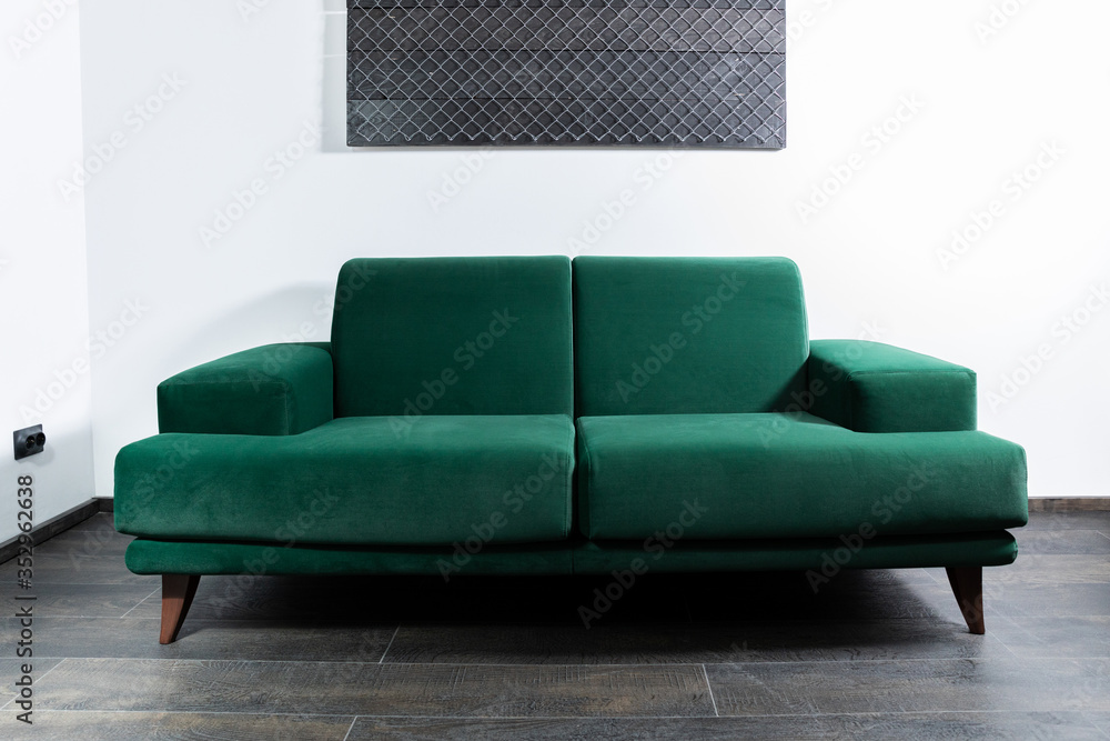 Green Sofa in the room with white walls