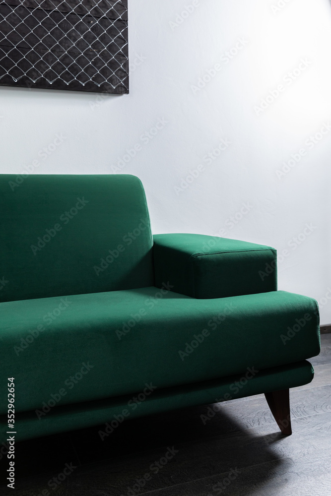 Green Sofa in the room with white walls