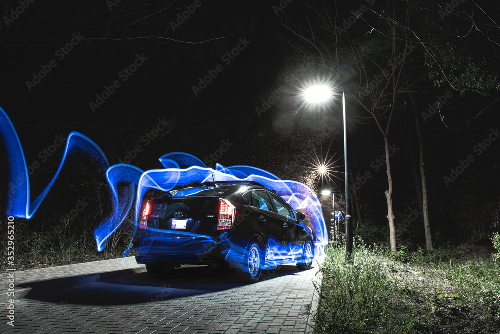 Night photography of a black car with special natural visual effects.