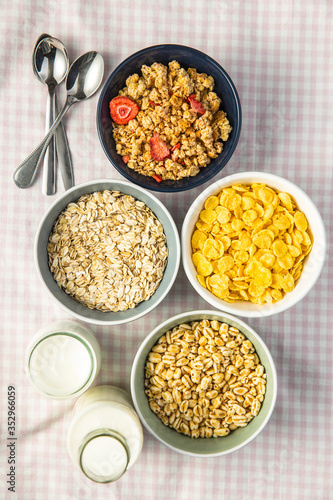 Various breakfast cereals in bowls. Puffed wheat and oatmeals.