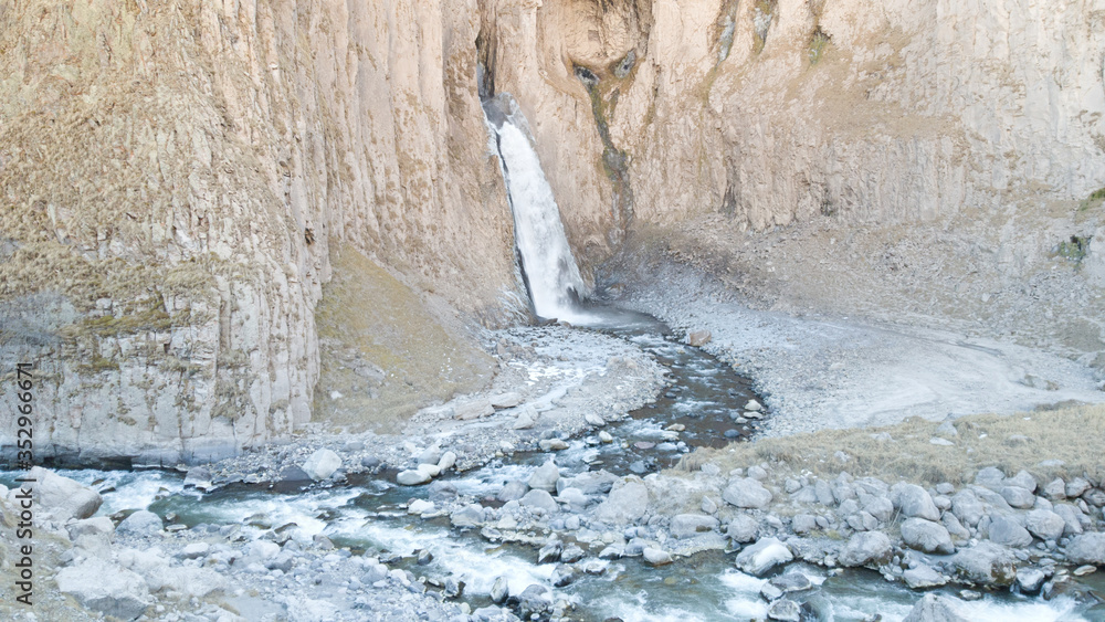Autumn mountains. Waterfall in the Caucasus mountains.