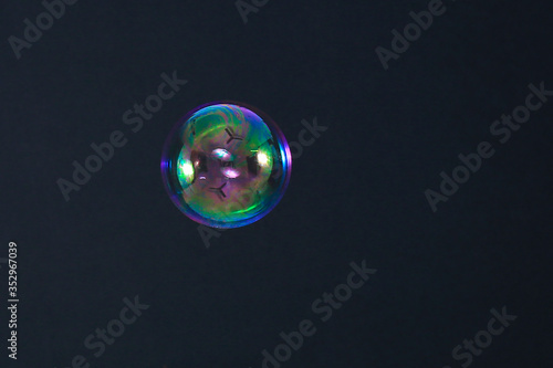 Beautiful rainbow soap bubble on a black background