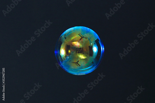 Beautiful rainbow soap bubble on a black background