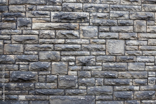 Textured stone wall background. Square patterns and rough texture