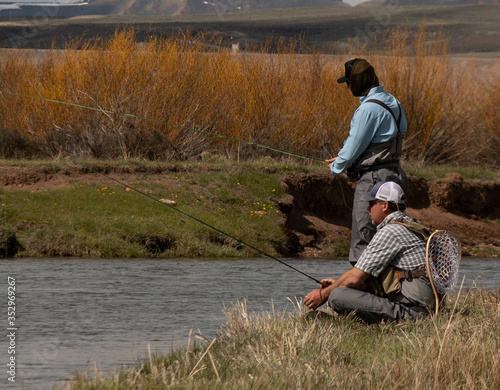 A father and son fly fishing on a wild trout stream.
