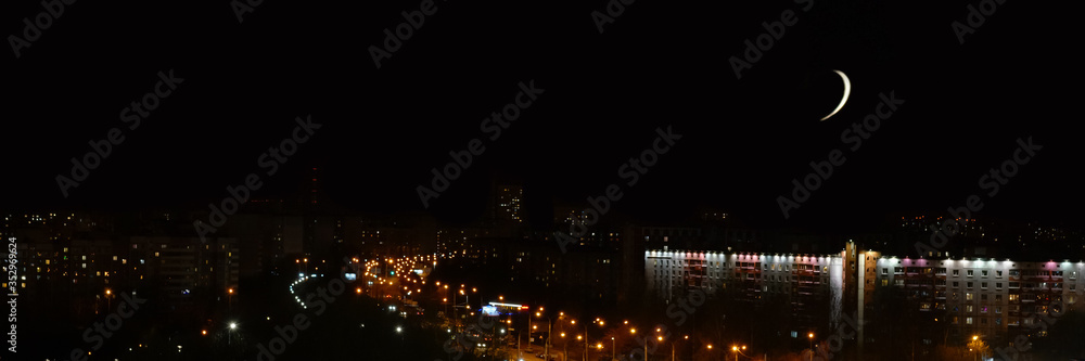 clear black sky with white moon over night city street