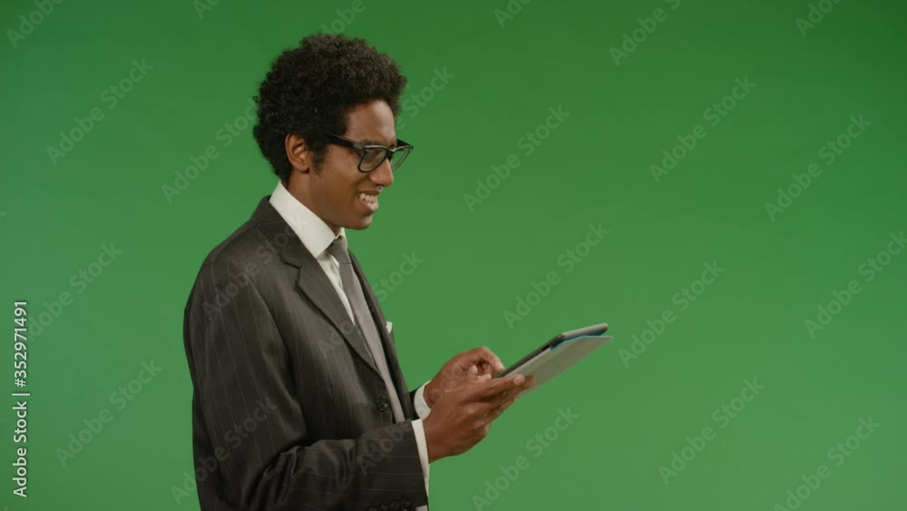 Happy Businessman Uses Tablet on Green Screen Happy Businessman Uses Tablet on Green Screen