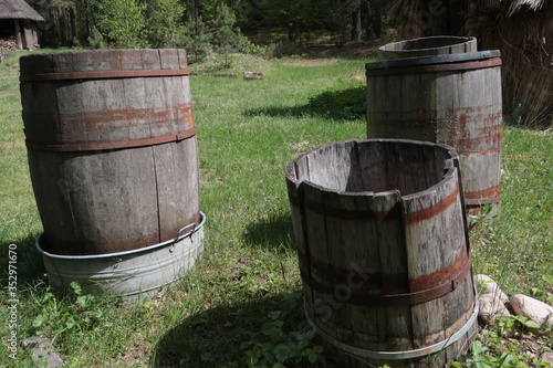 Old wooden barrels standing in the grass