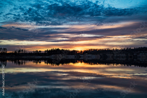 Mirror image of the sunset on the lake in spring.