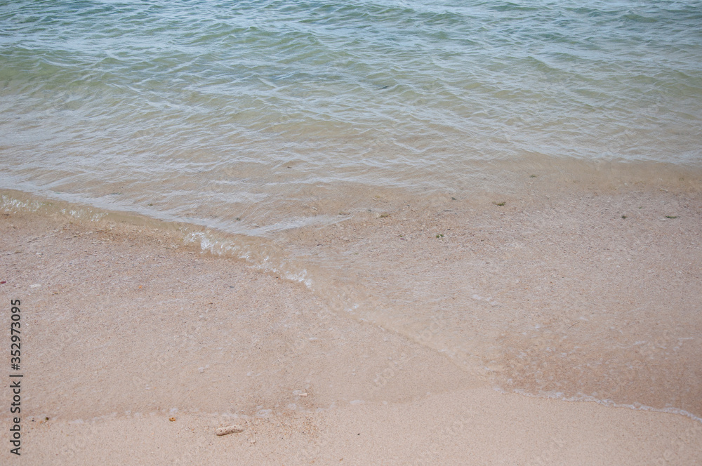 Close up of sand and water on the shores of a beach Close up of sand and water on the shores of a beach