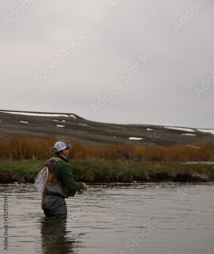 A man flying fishing on a wild trout stream in Wyoming.