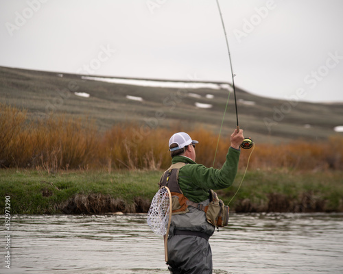 A man flying fishing on a wild trout stream in Wyoming.