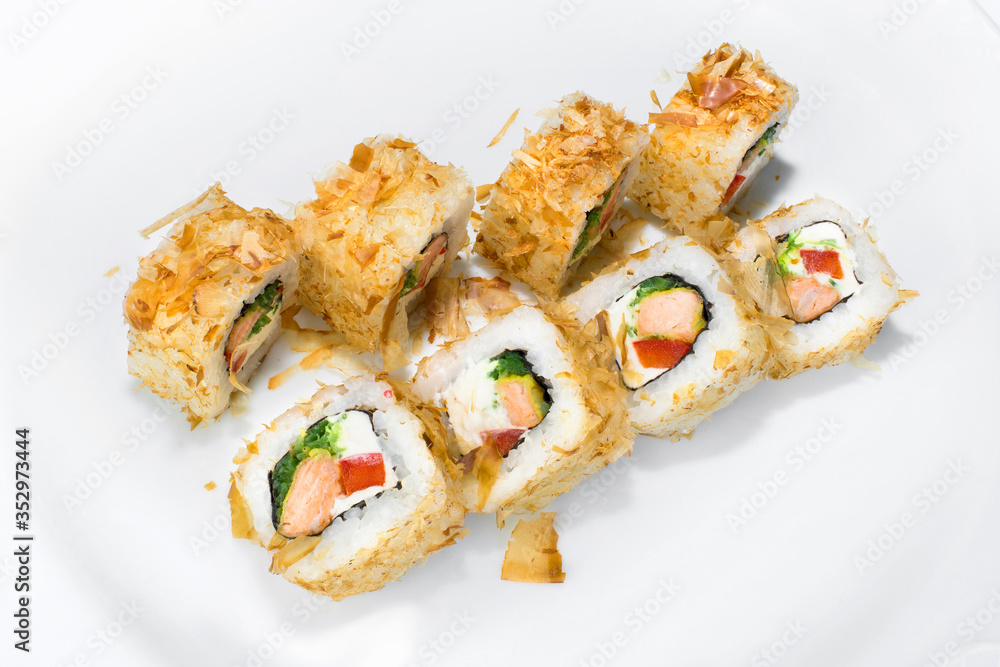 Japanese roll of rice, chukka, cream cheese, bell pepper, fried salmon and tuna flakes on a white background Japanese roll of rice, chukka, cream cheese, bell pepper, fried salmon and tuna flakes on a white background