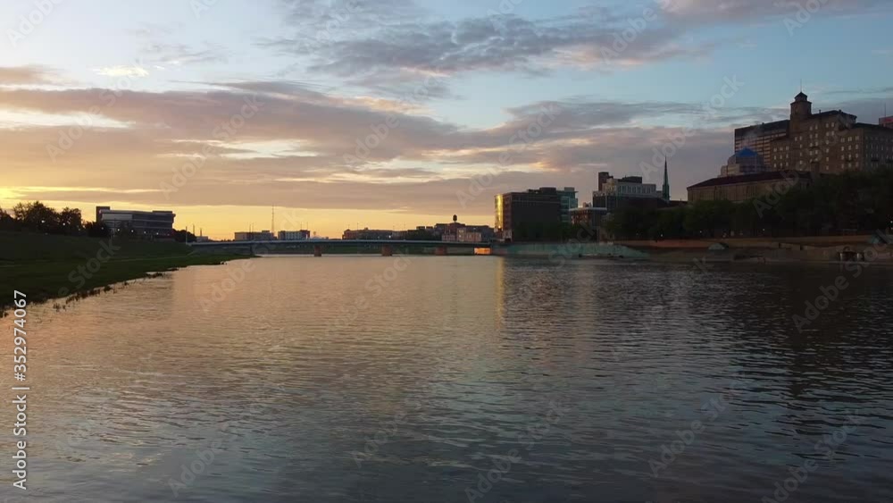 Forward then Up panDrone flying over miami river near Dayton at sunrise. Flying forward then panning up. Dayton buildings, bridges, and sunrise Forward then Up panDrone flying over miami river near Dayton at sunrise. Flying forward then panning up. Dayton buildings, bridges, and sunrise