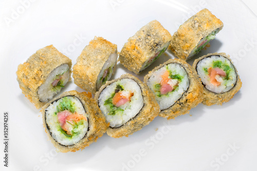 Traditional Japanese roll of rice, eel, salmon, tuna and chuka seaweed on a white background