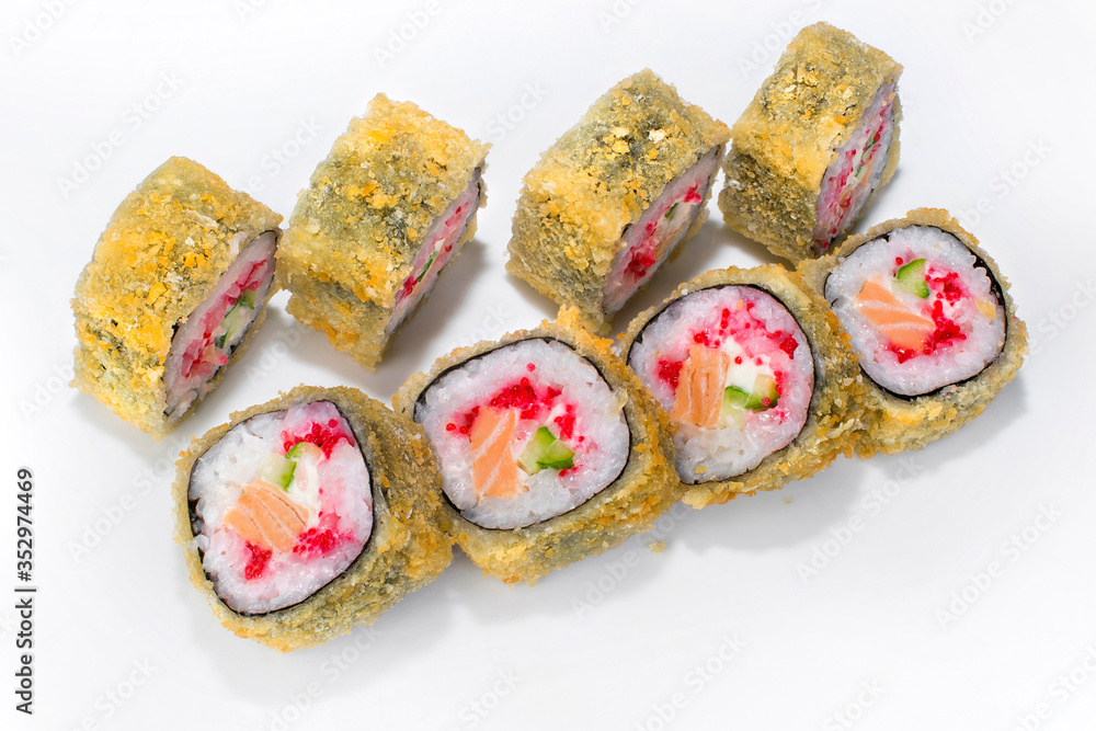 Japanese tempura roll of rice, salmon, cucumber, tobik and cream cheese on a white plate Japanese tempura roll of rice, salmon, cucumber, tobik and cream cheese on a white plate