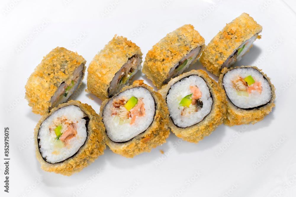 Japanese American roll of rice, mayonnaise, avocado, cucumber, salmon and eel on a white background Japanese American roll of rice, mayonnaise, avocado, cucumber, salmon and eel on a white background