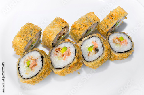 Japanese American roll of rice, mayonnaise, avocado, cucumber, salmon and eel on a white background