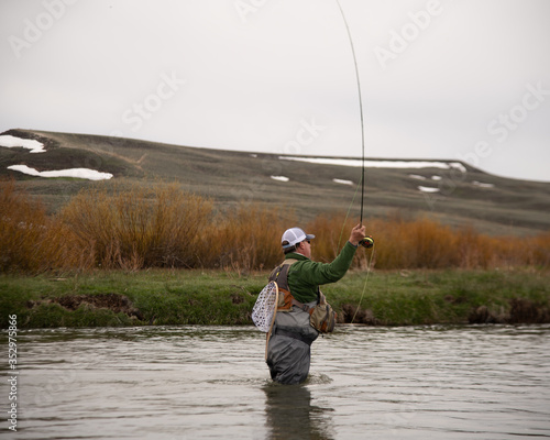 A man fly fishing on a western trout stream.
